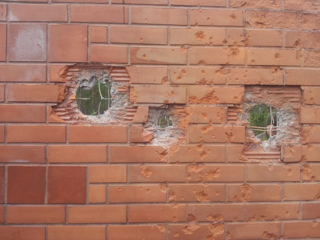 Impact holes from 30mm autocannon in reinforced concrete.